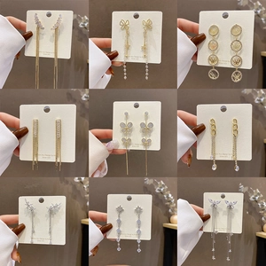 Set of 9 elegant 925 silver needle drop earrings with gold finish and zircon stones