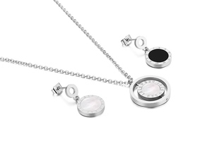 Detail of silver stainless steel necklace and earrings with shell inlay and Roman numerals