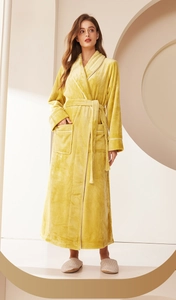 Detail view of a long yellow flannel bathrobe with shawl collar and white piping trim