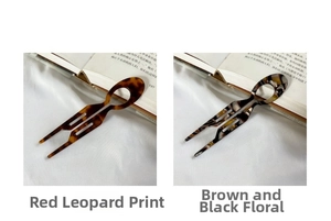 Detail view of U-shaped acetate hair pins in leopard and marble tortoise shell patterns
