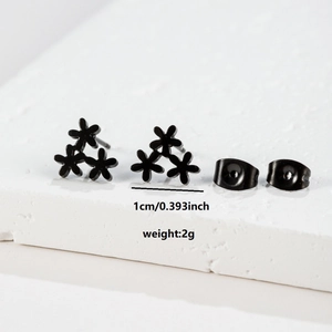 Macro view of black stainless steel floral stud earrings showing 1cm size and 2g weight
