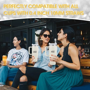 Three models holding tumblers with 10mm straw covers and flower charms in sunny outdoor