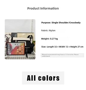 Detailed view of large black and white nylon messenger bag with dimensions 32x12x27cm