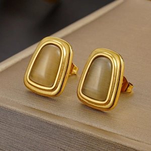 French chic gold-plated stud earrings with champagne cat eye stones in a jewelry box