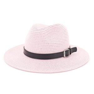 Close-up of pink straw sun hat texture with black leather band and silver metal buckle