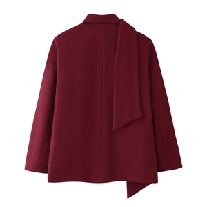 Detail view of the asymmetric burgundy wool coat with draped back design on white background