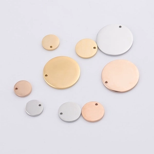 Detailed flat lay of round stainless steel blank tags in gold, rose gold, and silver finishes