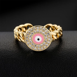 Golden curb chain open ring featuring a pink evil eye motif with sparkling cubic zirconia