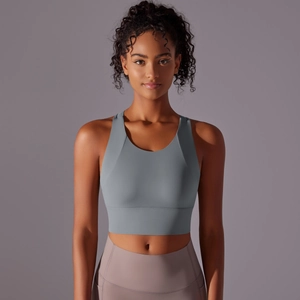 Front view of grey-blue sports bra with wide shoulder straps and supportive wide hemline
