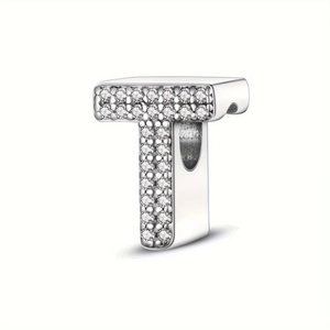 Macro shot of silver letter T bead with pavé crystals and polished metal finish