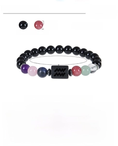 Detail of 8mm natural obsidian zodiac bracelet showing beads and Aquarius symbol