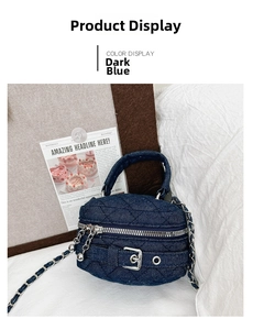 Detail view of dark blue quilted denim handbag with silver buckle and chain strap