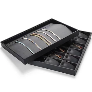Black PU leather jewelry display trays for necklaces and bracelets on white background