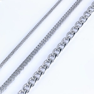 Polished silver stainless steel Cuban link necklaces in three different widths on white