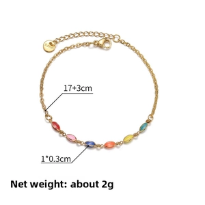 Detail showing 14K gold-plated stainless steel bracelet with colorful enamel charms