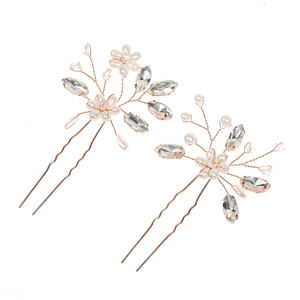 Detailed view of rose gold bridal hair pins featuring white pearls and clear crystals