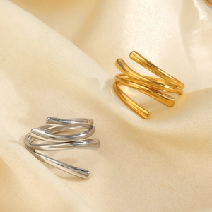 Chunky 18K gold and silver plated stainless steel spiral rings on soft silk fabric