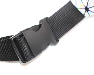 Detailed close-up of plastic buckle and colorful geometric holographic waist bag strap