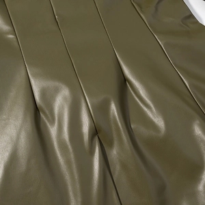 Detailed macro view of olive green PU leather texture and vertical stitching finish