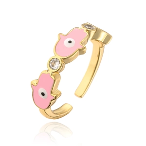 Detail of 18K gold plated Hamsa ring with pink enamel hand and sparkling zircons