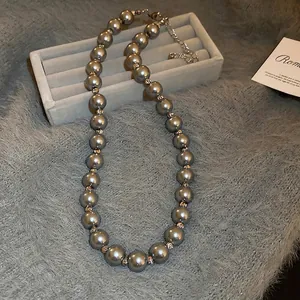 Elegant French-style grey pearl necklace with golden faceted beads and extension chain