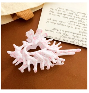 Close-up of pink marble pattern hair claw clip with coral-shaped resin design