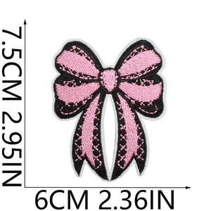 Detailed embroidery texture of pink and black bow patch with precise dimensions