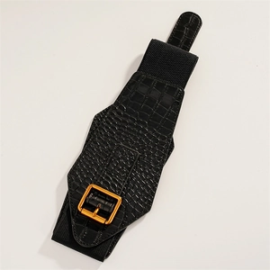 Close-up of black crocodile pattern leather waist belt with a golden rectangular buckle