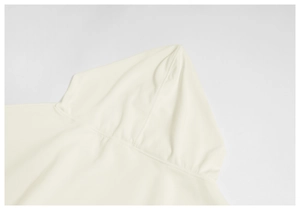 Detail of hood stitching and knit texture on cream-colored loose fleece hoodie