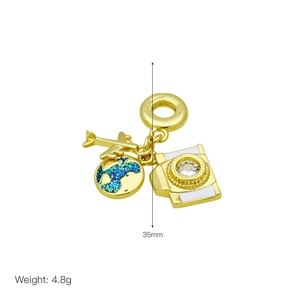 Detailed view of gold pendant with airplane, enamel globe, and camera charms