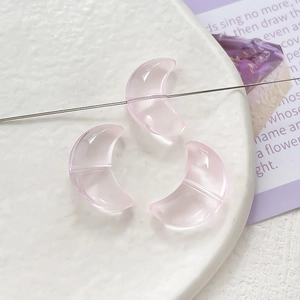 Close-up of pink crescent moon gradient glass beads for DIY jewelry making
