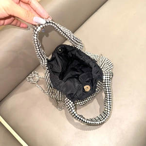 Silver rhinestone bucket bag interior with black lining and metal chain strap