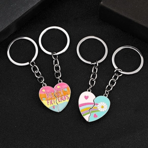Rainbow magnetic Best Friends heart keychains with daisy patterns on black background