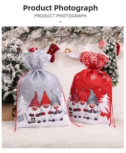 Close-up of Christmas gnome drawstring gift bags with snowflake patterns on white fur background