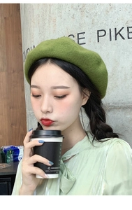 Close-up of grass green wool beret hat showing soft texture and high-quality wool fabric