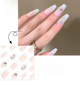 French tip press-on nails with nude base, white edges, and sparkling star crystal accents
