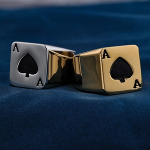 Detail of square signet rings with Ace of Spades engraving in gold and silver finishes