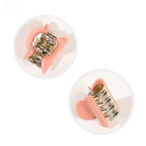 Detail view of pink acrylic mini hair claw clip showing glossy finish and metal spring