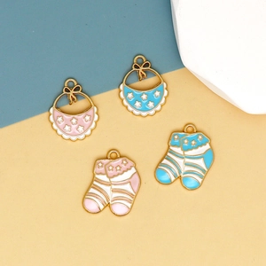 Cartoon baby bib and sock alloy charms with pink and blue enamel and gold stars