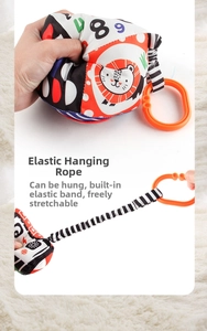 Elastic hanging cord detail on newborn cloth book with lion pattern and orange ring