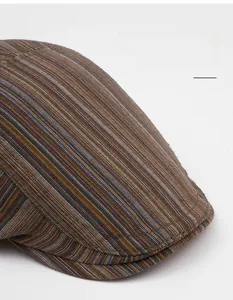 Close-up of the textured woven fabric and striped pattern on the vintage flat cap brim