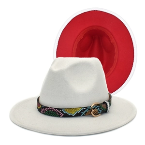 Detail of felt fedora hat showing dual-tone cream and red fabric with snakeskin belt