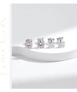 Detail of S925 sterling silver four-prong stud earrings with round moissanite stones