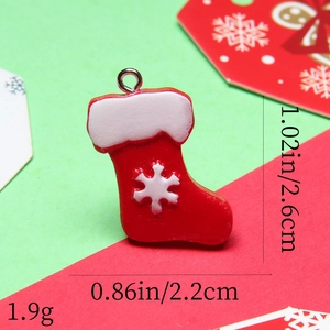 Detailed view of resin Christmas stocking charm with snowflake pattern and size dimensions