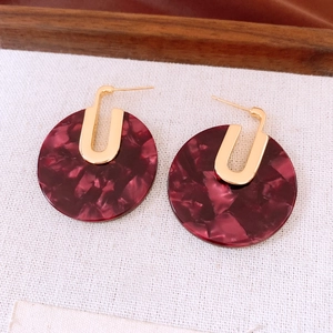 Detailed macro view of 18K gold plated tortoiseshell acetate hoop earrings with marble pattern