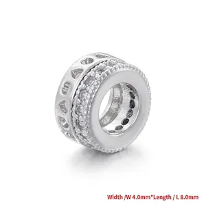 Macro view of 8.0mm silver charm bead with paved zircons and heart hollow pattern