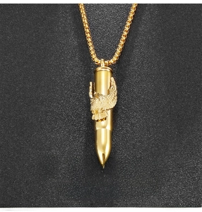 Close-up of golden bullet pendant featuring a detailed eagle relief on a box chain