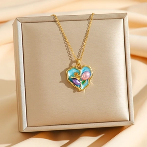 Vintage style heart pendant necklace with natural pearls on a gold silk background