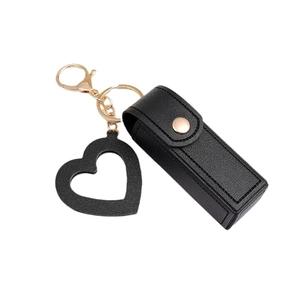 Black leather lipstick holder keychain with golden heart charm and minimalist design
