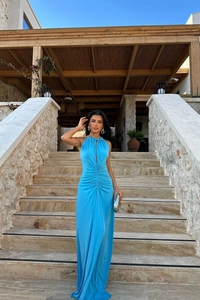 Detailed close-up of blue halter dress featuring front cutout and elegant ruched texture